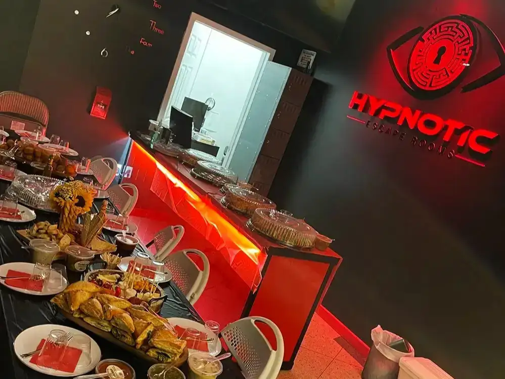 Catered platters laid out along the lobby's red-lit counter