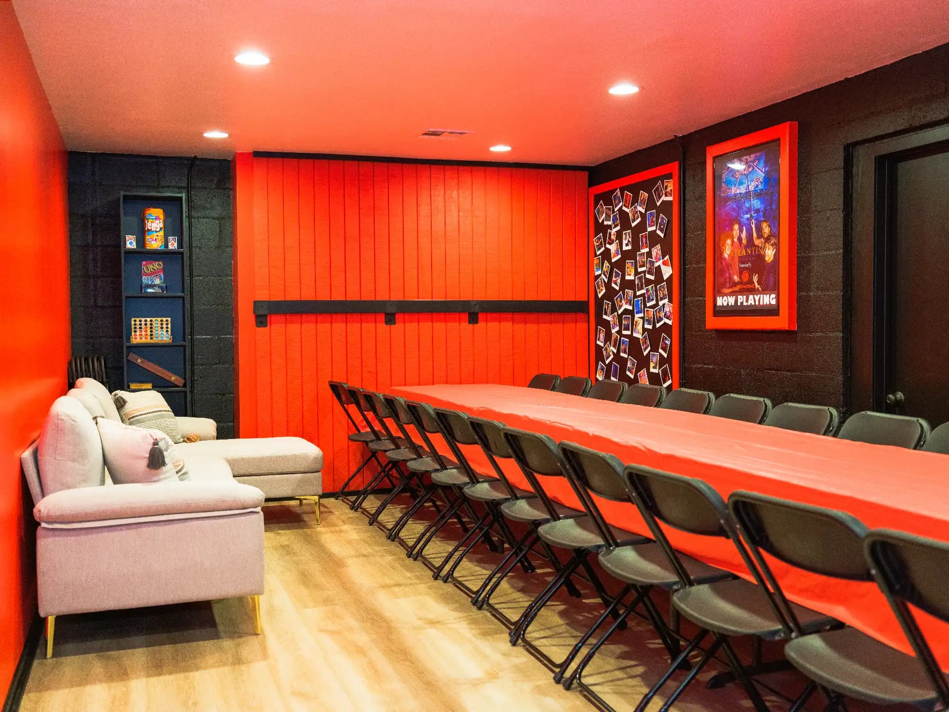 The party room from the sofa end, the table set with chairs for a full group