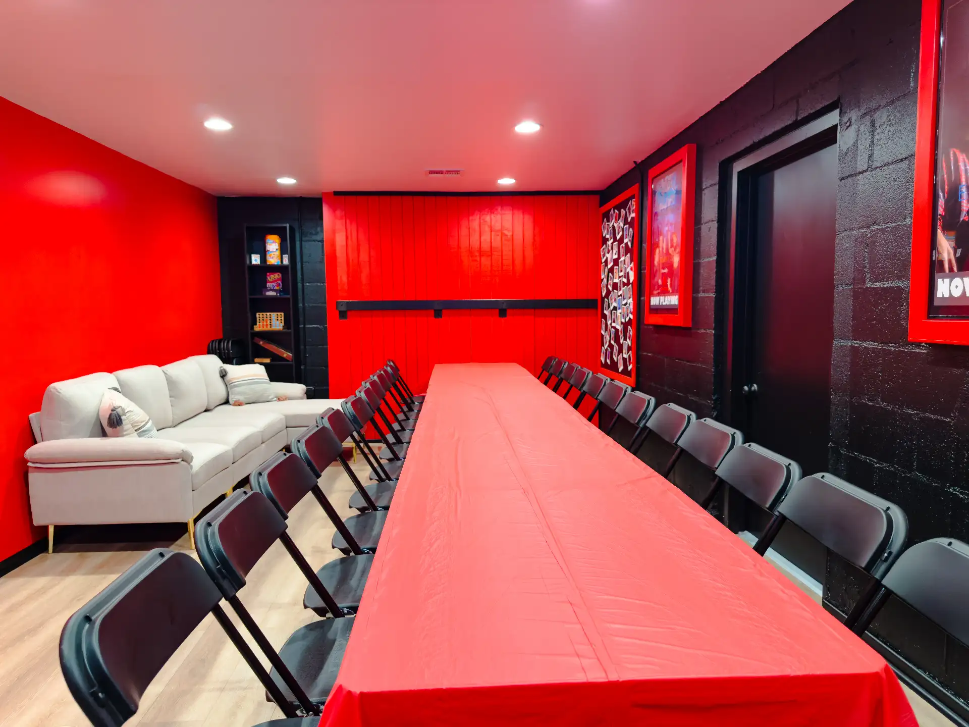 The lounge sofa and the red banquet table in the private party room, lit red