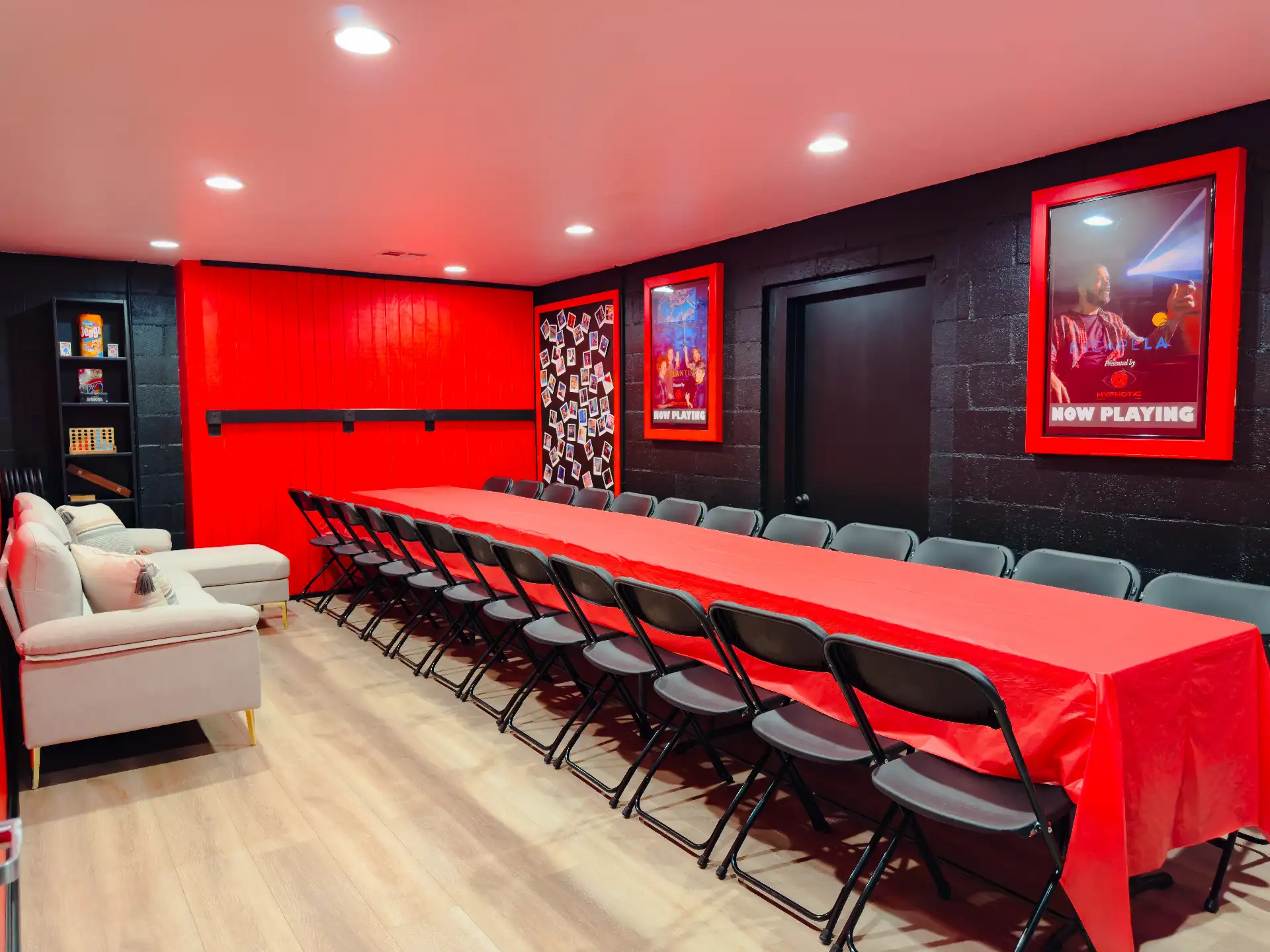 Chairs pulled up along the banquet table beneath the framed escape-room posters