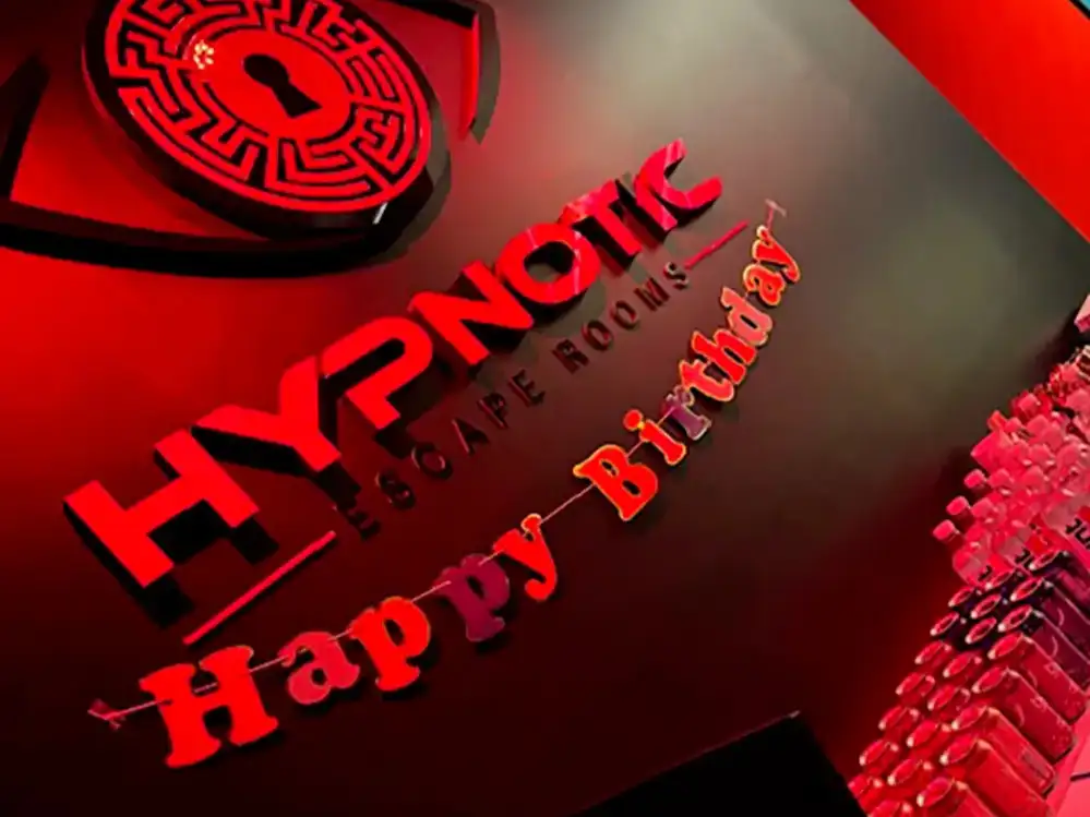The red backlit Hypnotic 'Happy Birthday' sign filling the lobby wall